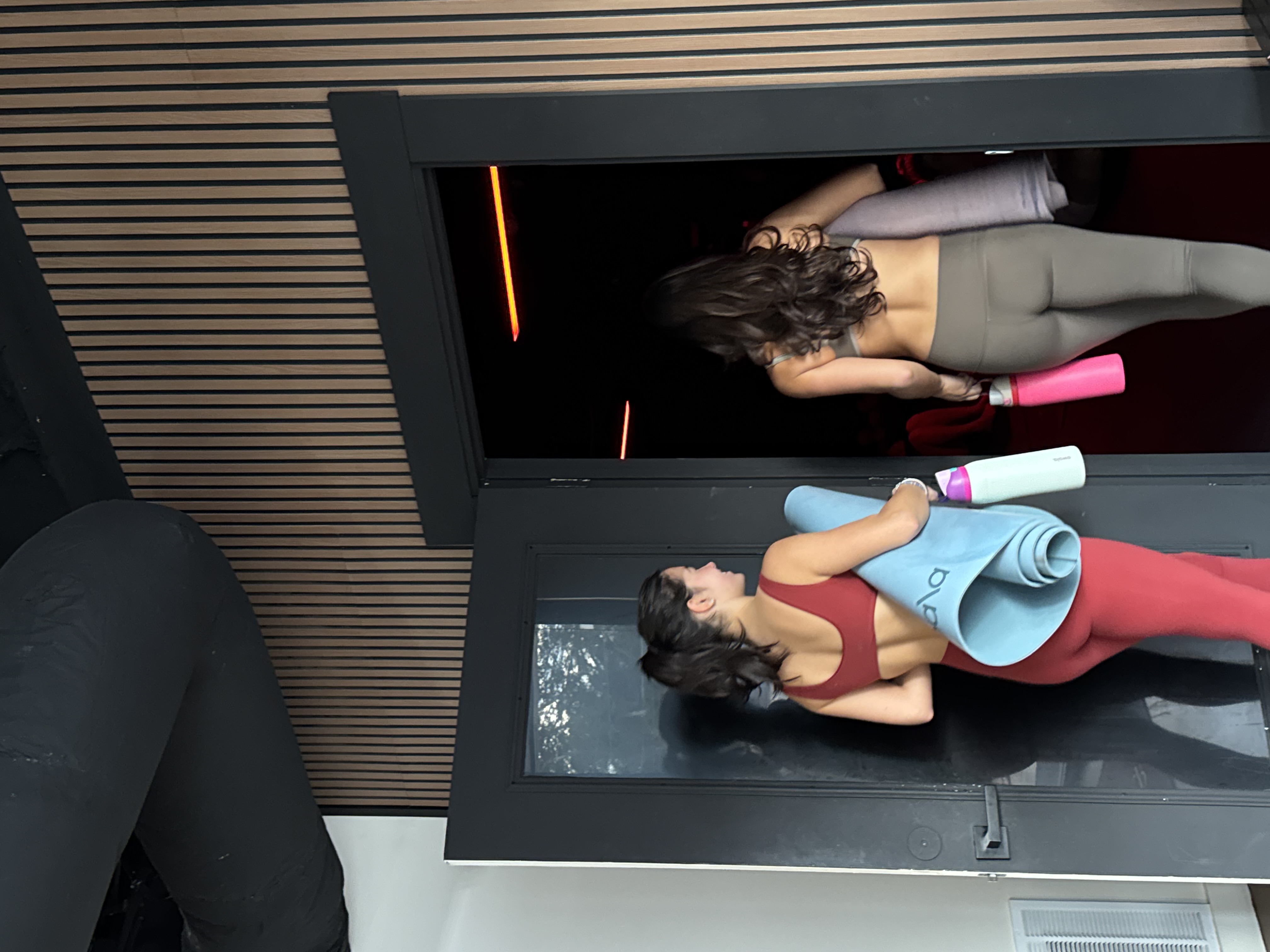 Two women walking into Flowstate heated fitness studio