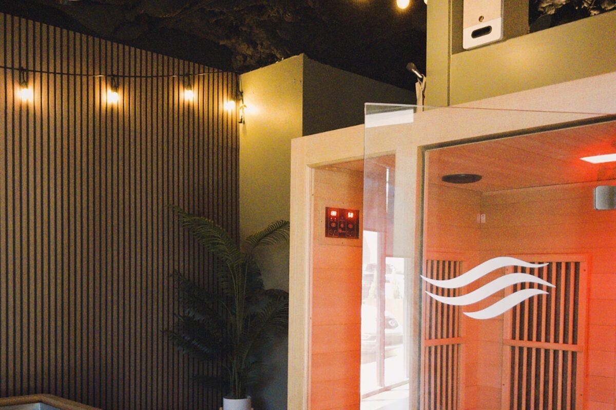 The Oasis recovery room at Flowstate — infrared sauna and cold plunge pools with ambient lighting