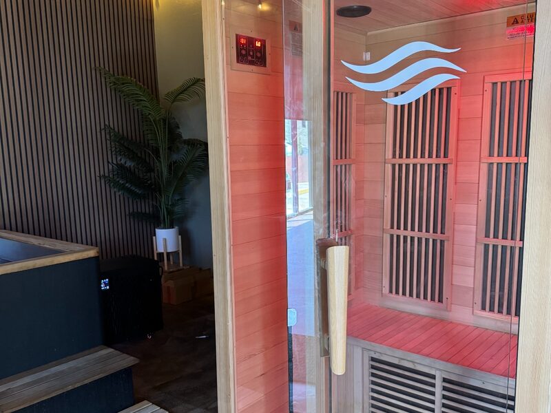 Infrared sauna with Flowstate wave logo and cold plunge in background