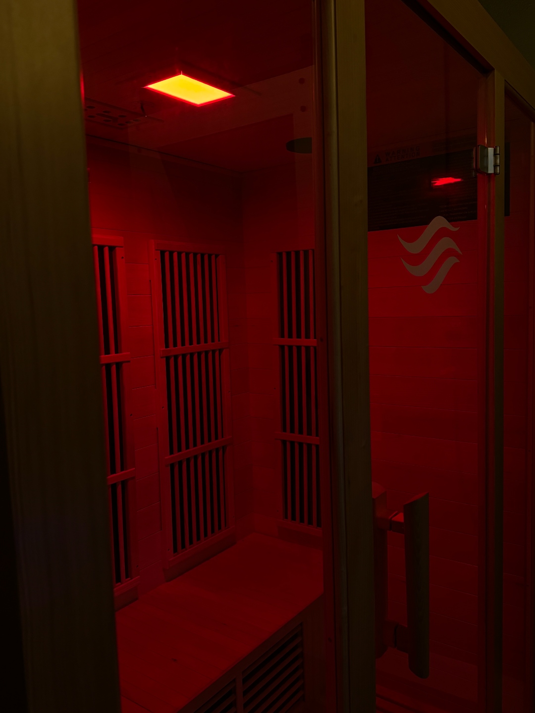 Inside the infrared sauna at Flowstate with warm red glow