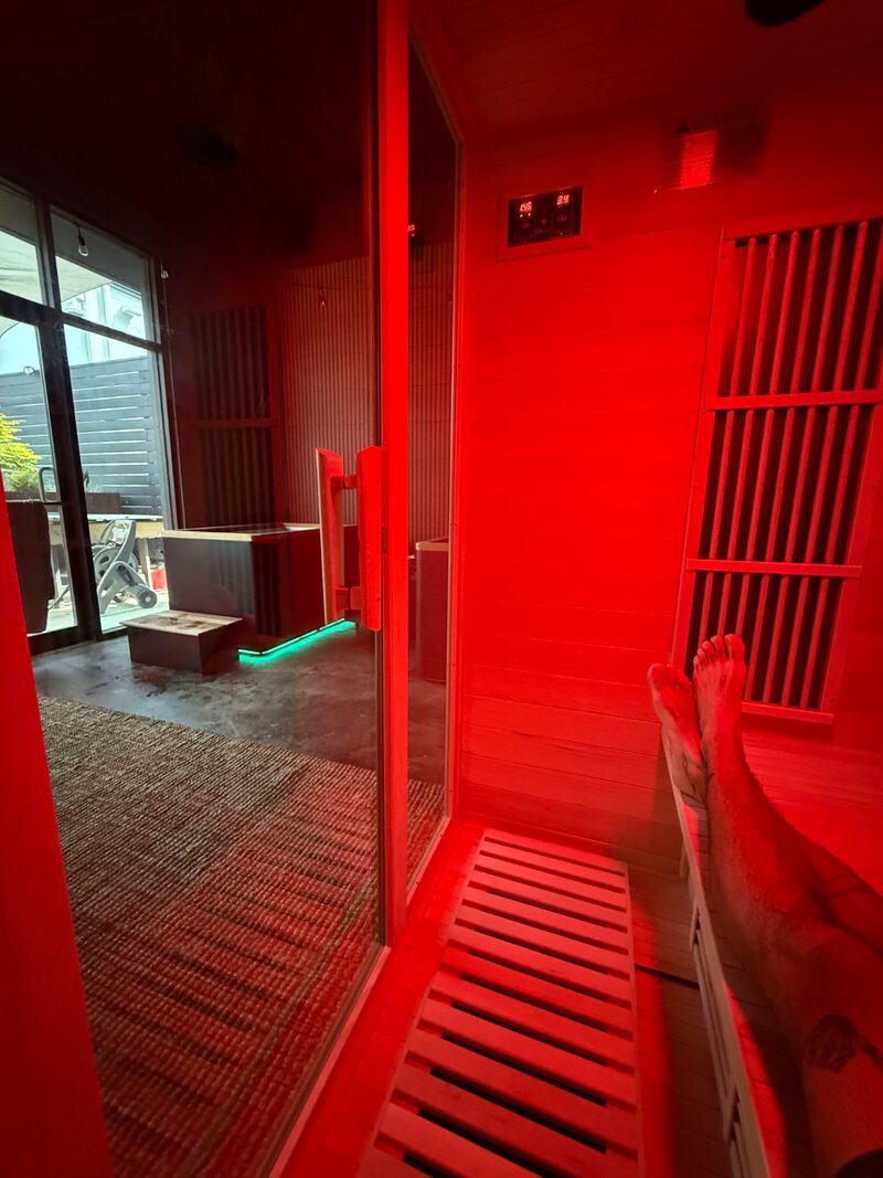Inside the infrared sauna looking out, warm red glow